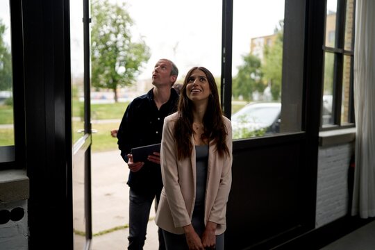 Couple Explores Modern Interior in Urban Space During Daylight