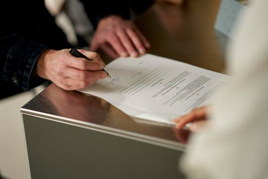 Signing a Contract at a Modern Office During Daylight Hours