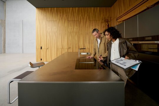 Couple Discussing Kitchen Design in a Modern Space