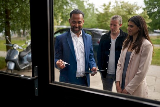 Real estate agent showing property to potential buyers