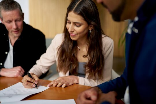 Business meeting with document signing in office setting