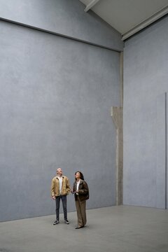 Visitors Admire the Spacious Interior of a Modern Space 