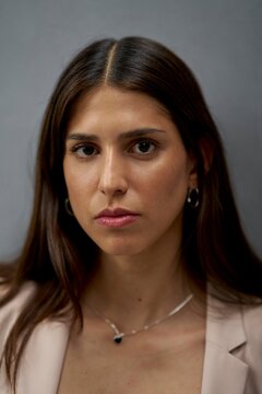 Woman in business attire poses with long hair