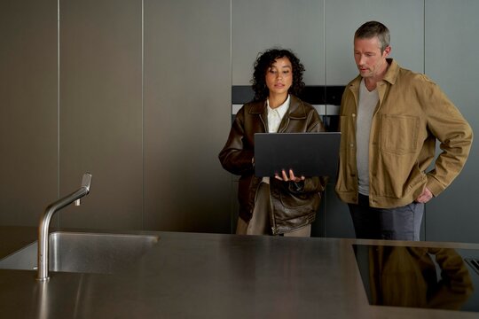 Man and Woman Discussing Kitchen Renovation Ideas in Modern Setting