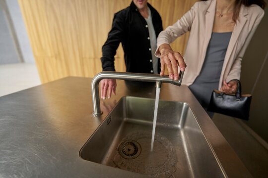Couple Interacting With a Modern Sink in a Stylish Kitchen