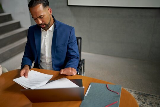Professional Man Reviewing Documents in an Office Setting