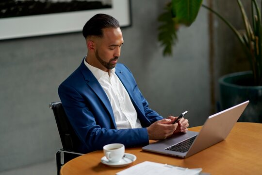 Businessman Working on Smartphone in Modern Office Setting
