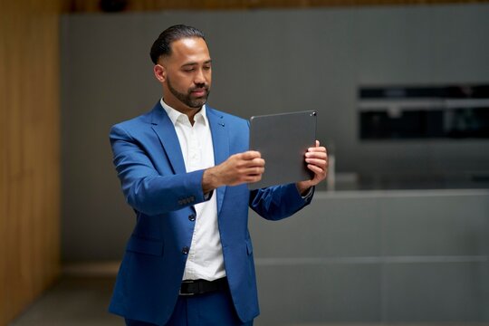Business professional engaging with tablet in modern office space