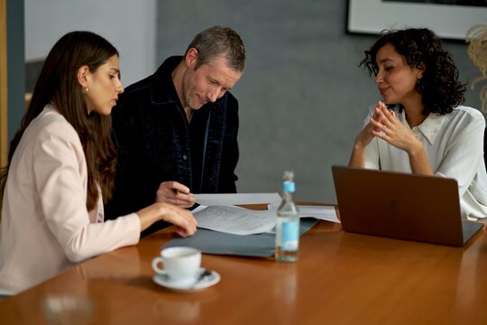 Business Meeting With Discussion and Documents at Modern Office