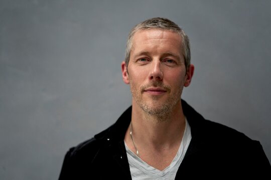 Person With Short Gray Hair and Casual Attire Posing for Portrait