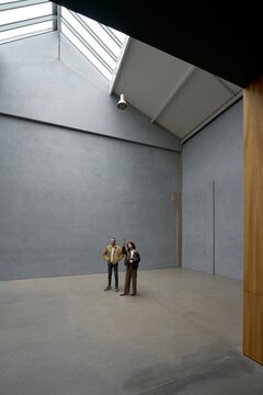 Two People Standing in a Spacious Modern Apartment 