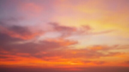 Obraz premium A soft blurred sky transitioning from violet and pink to warm orange and yellow with vibrant red clouds at the horizon