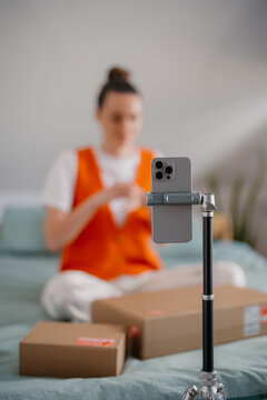 A woman shoots a video blog on a mobile phone