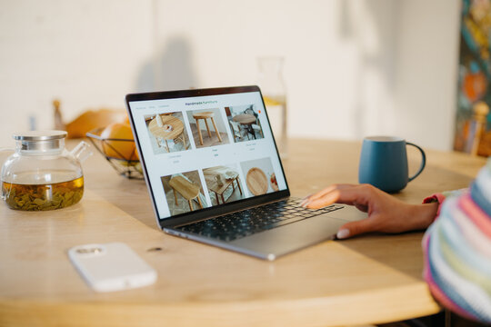 A woman makes online purchases on a laptop