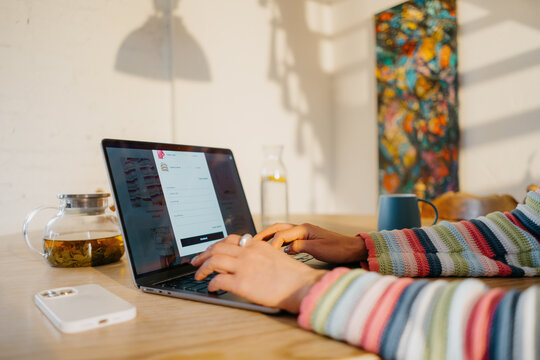 A woman makes online purchases on a laptop