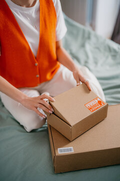 A woman unpacks delivery boxes