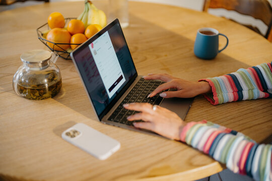 A woman makes online purchases on a laptop