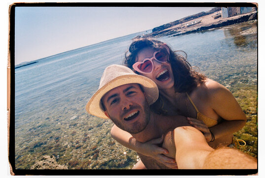 Happy young couple film selfie
