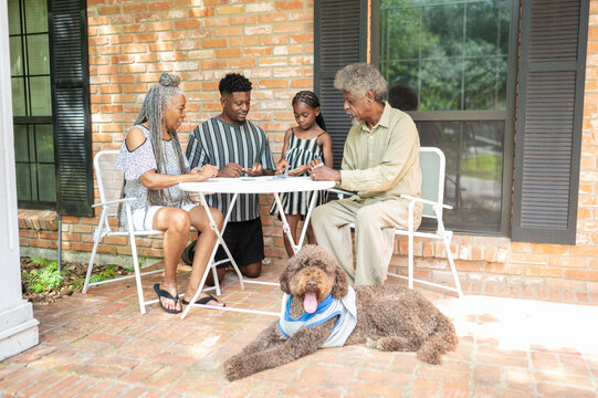 Multigenerational family playing a card game at home