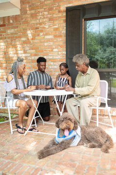 Multigenerational family playing a card game at home