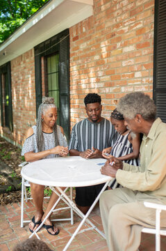 Multigenerational family playing a card game at home