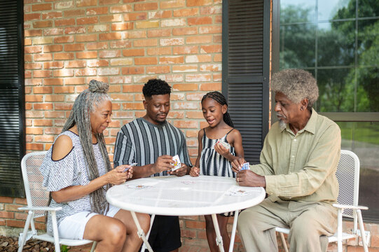 Multigenerational family playing a card game at home