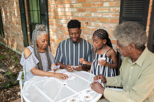 Multigenerational family playing a card game at home
