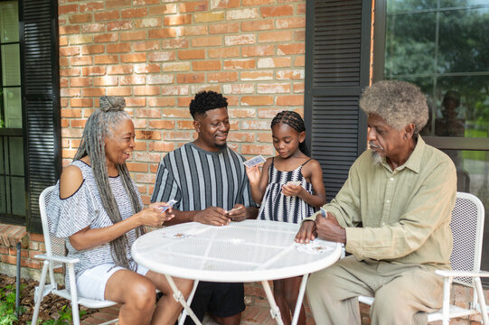 Multigenerational family playing a card game at home