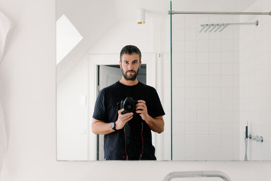 Self-portrait of a photographer capturing a selfie with a pro camera