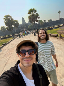 Men Walking Toward Angkor Wat on Stone Path