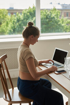 Woman working on laptop at home