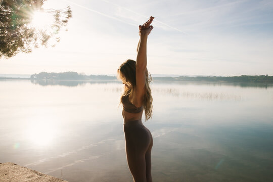 Serene morning yoga by the lakeside with beautiful sunrise glow
