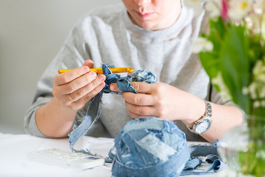 Upcycling. Unrecognizable woman crocheting with yarn