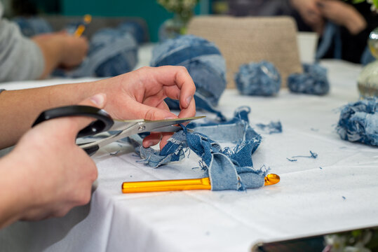Upcycling. Unrecognizable woman crocheting with yarn