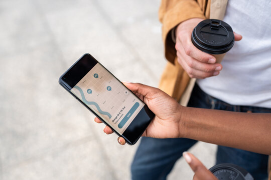 People using bike sharing app on smartphone in urban environment
