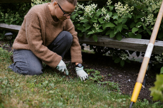 woman gardening in her front yard 