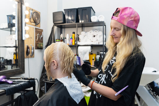 Hairdresser Dyeing Woman's Hair