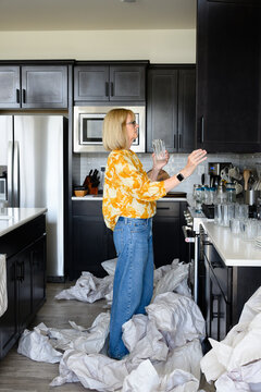 Mature woman unpacking after a move