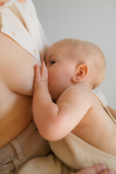 Mother and baby bonding during breastfeeding session at home