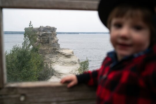Young Child Dressed as Park Ranger Outdoors
