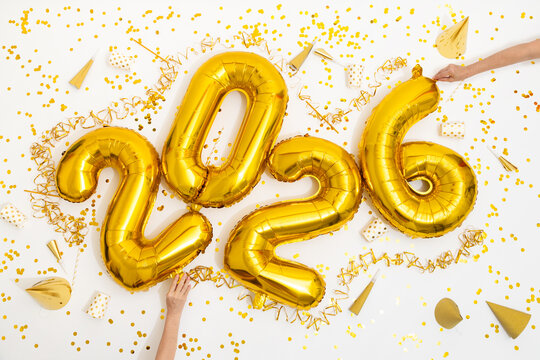 Celebration With Golden Balloons and Confetti for New Year 2026