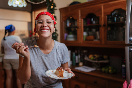 Happy woman eating flan
