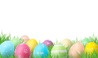 Fototapeta premium Easter eggs in green grass against white background