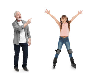 Fototapeta premium Grandpa spending time with his granddaughter on white background. Girl roller skating