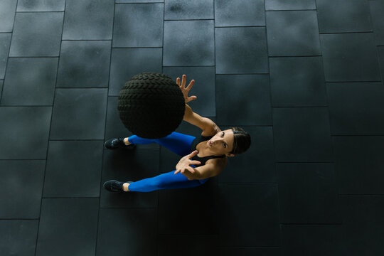 Woman Exercising With a Medicine Ball in a Gym Setting