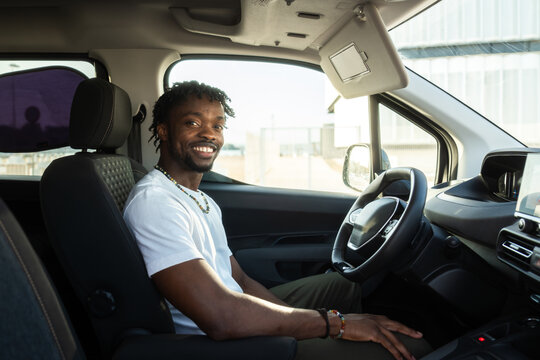 Confident man smiling behind the wheel