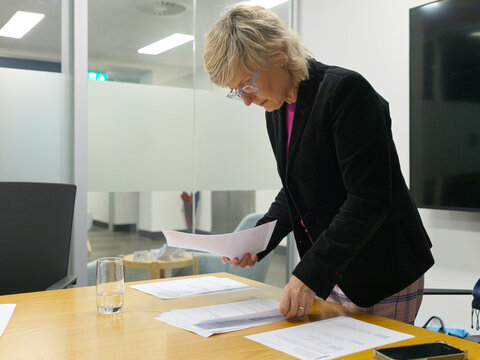 Professional Woman Reviewing Documents in Modern Office Setting