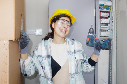 portrait of a young woman with a screwdriver in her hand