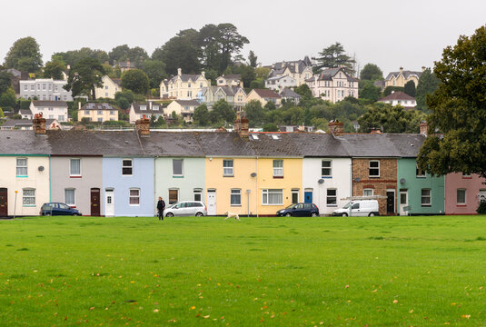 UK, England, Devon, Newton Abbot. Row of cottages on the edge of a village green.