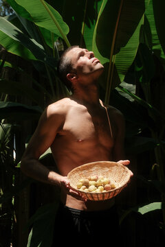 Man Holding Fruit in Florida Sun